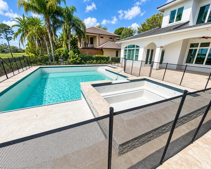 Lagoon style screened pool with a natural rock waterfall on a Central Florida lake