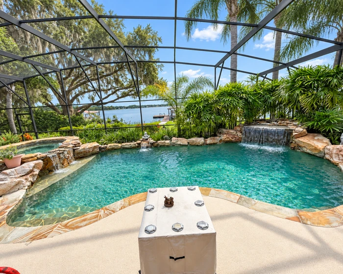 Kidney shaped pool with raised spa and paver deck during a resurfacing job