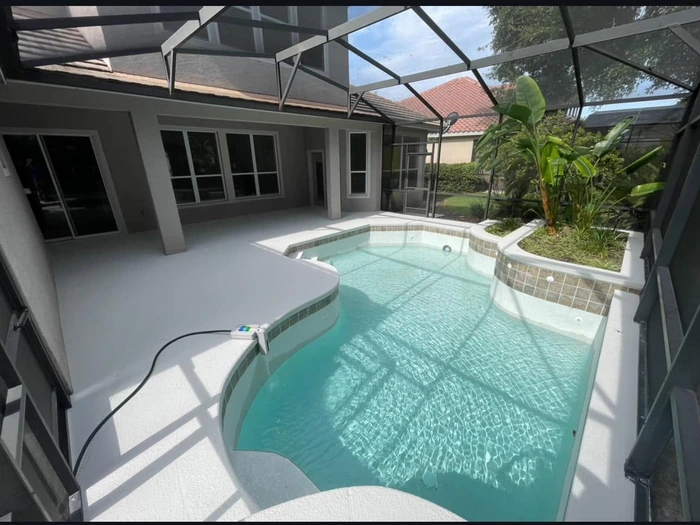 Exposed PVC plumbing repair beside a kidney shaped pool